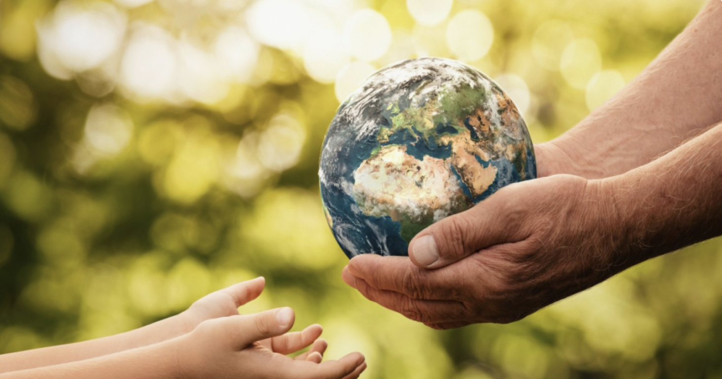 Hands passing the Earth